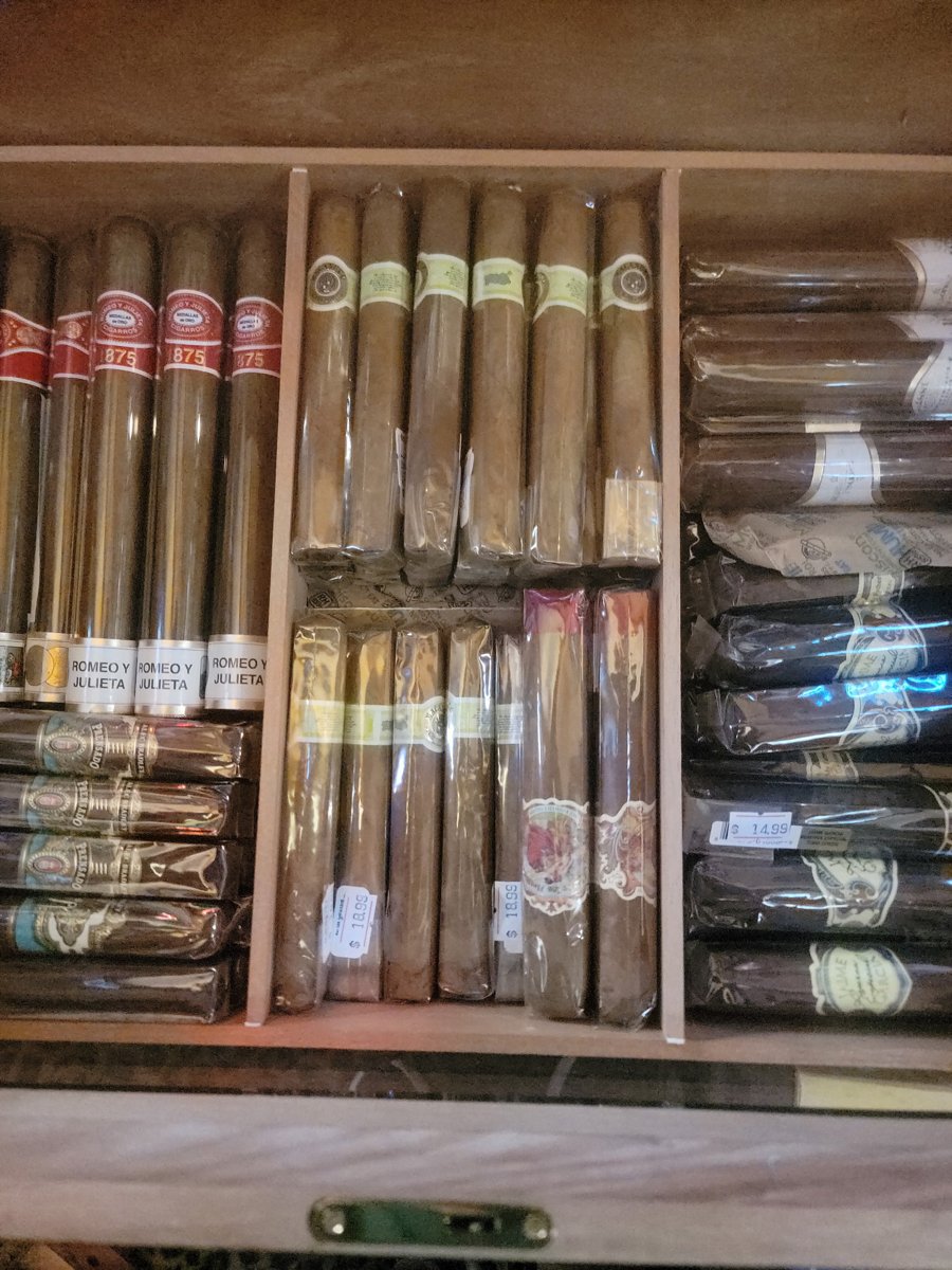 Individually wrapped cigars arranged in the store humidor