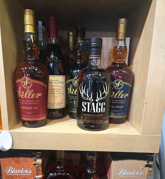 Allocated bourbon shelf with Weller, Stagg, Van Winkle, Blanton&rsquo;s, and EH Taylor bottles